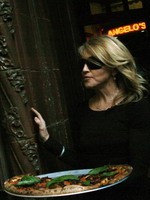 Madonna eating a pizza with David Letterman at Angelo's Pizza