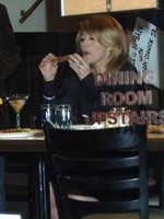 Madonna eating a pizza with David Letterman at Angelo's Pizza