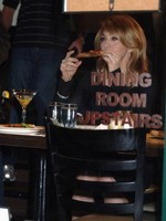 Madonna eating a pizza with David Letterman at Angelo's Pizza