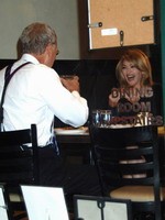 Madonna eating a pizza with David Letterman at Angelo's Pizza