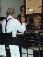 Madonna eating a pizza with David Letterman at Angelo's Pizza